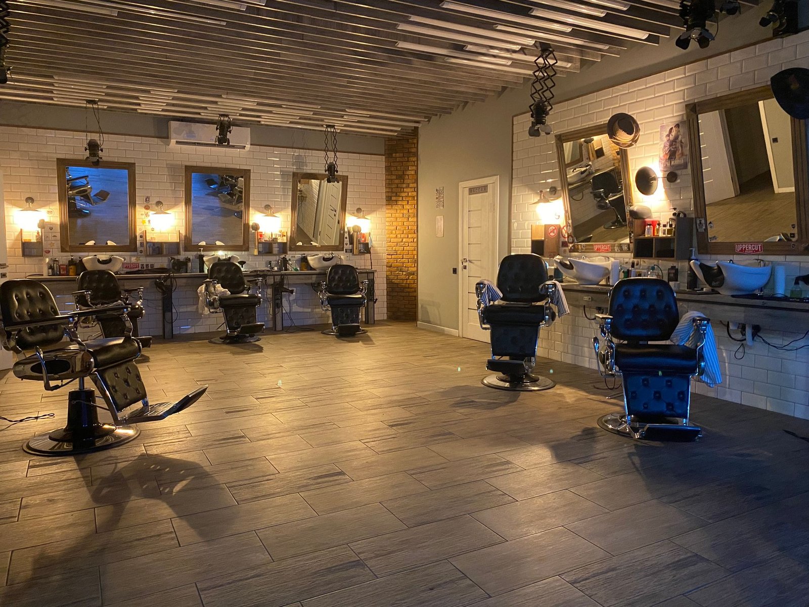 Interior of a modern hair salon with styling chairs, large mirrors and a bright, open fit-out