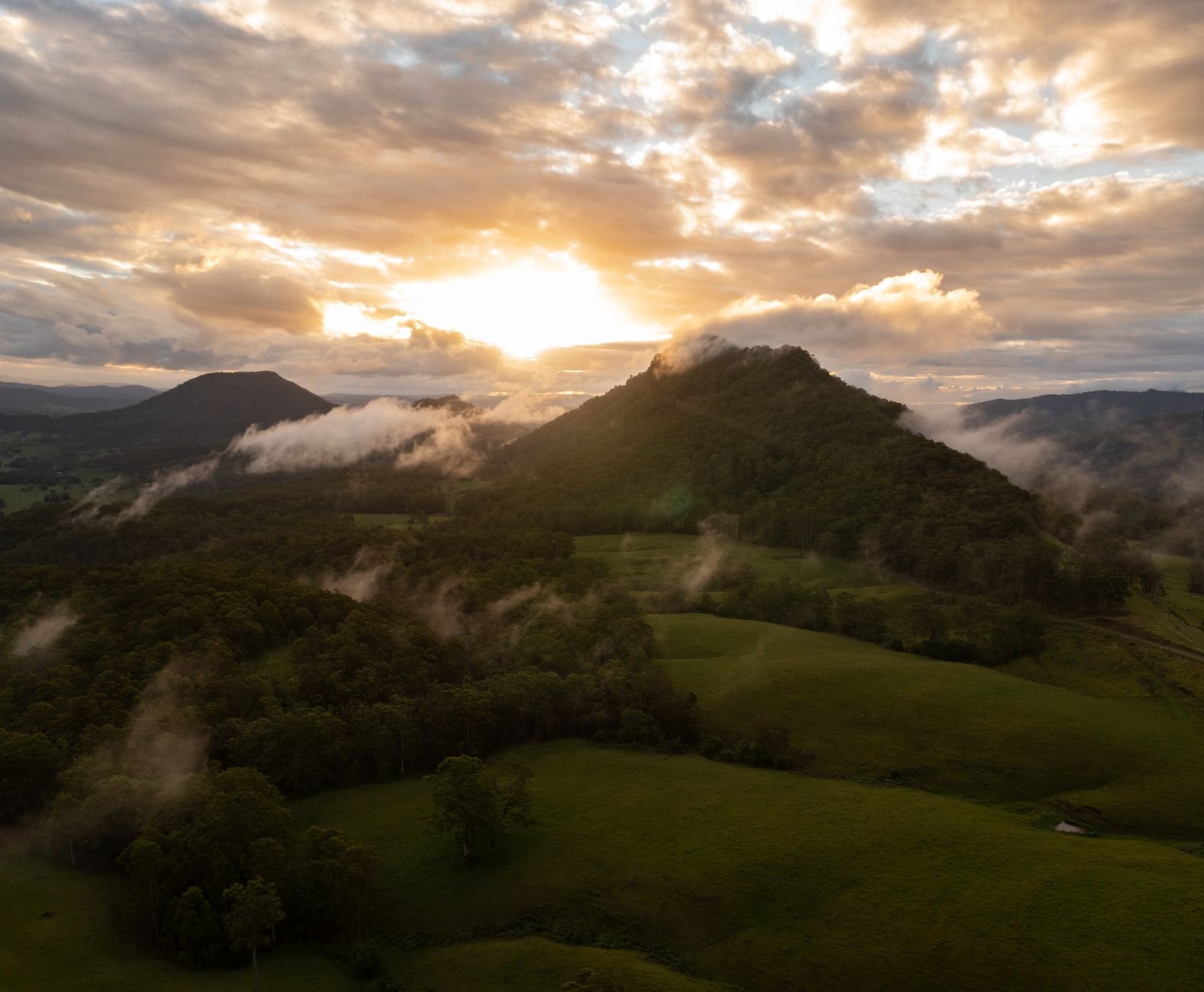Misty green hills and river valley of the Tweed caldera around Murwillumbah at sunrise